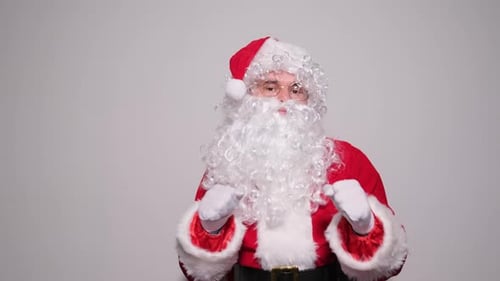 Man in Santa Costume Gesturing Toward Camera