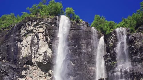 Breathtaking waterfalls of the Geiranger fjord, Norway. Immense volumes of water falling from the h