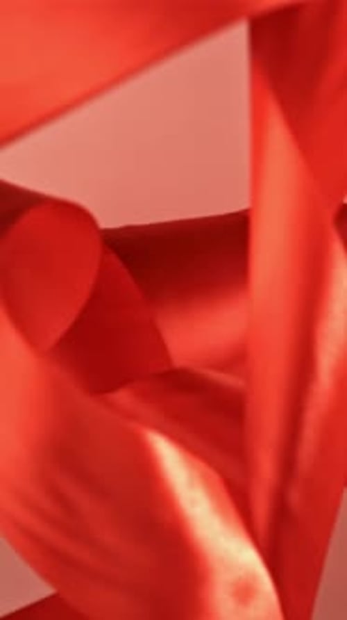 A Red Ribbon Falls on the Table Filmed on a Highspeed Camera at 1000 Fps