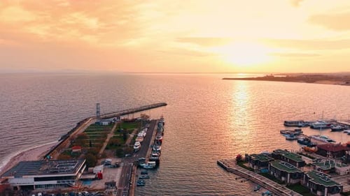 Harbor with numerous diverse boats. Drone footage approaching the vast seascape colored