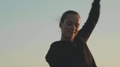 Young Woman Plays with Kite in Golden Hour