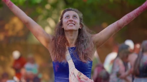 Girl at Indian Holi Festival in Colorful Dry Paints Rejoices and Enjoys Fun