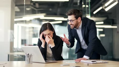 Office Argument with Woman Touching Face