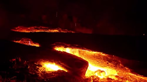 4K Close Up Camp Fire Burning Through Log With Lit Embers And Smoke