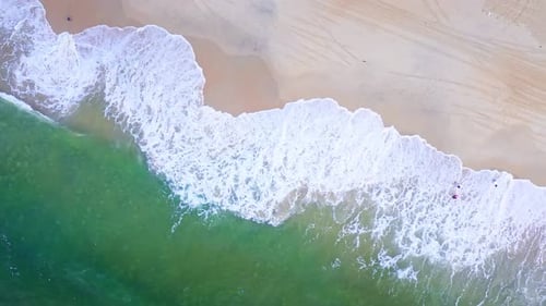 Aerial Top view of a transparent blue sea with beautiful waves at sunny day in summer. air of ocean