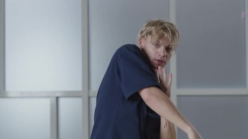 Blonde Young Man Dancing with His Hands Energetic Guy in Tshirt Gesturing to the Music Beat Studio