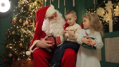 Santa Claus with Boy and Girl in Christmas Scene