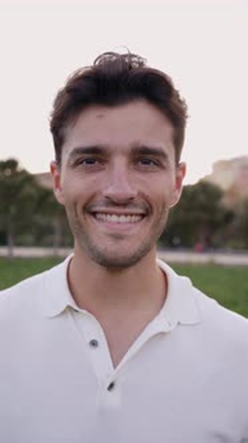Vertical Portrait of Attractive Smiling Young Man Looking at Camera in Park Caucasian Male Handsome