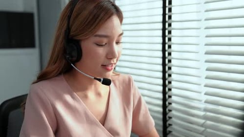 Competent Female Operator Working on Computer and While Talking with Clients