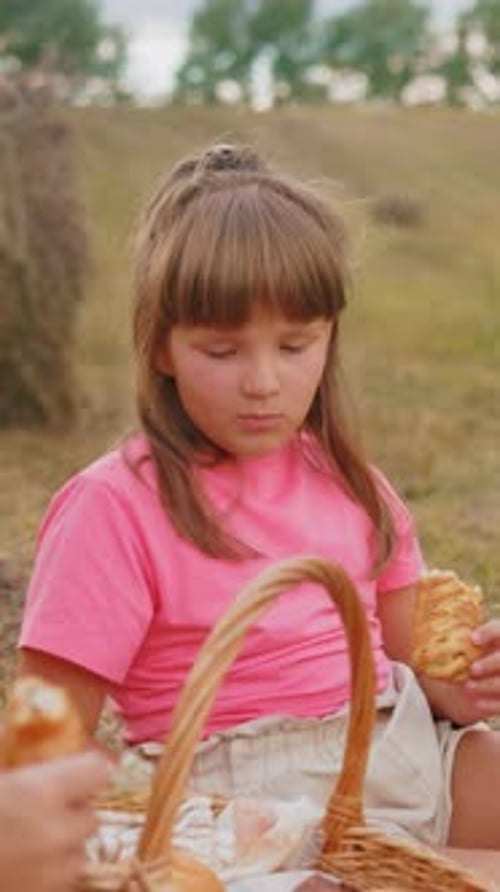Child Eating Pastry During Countryside Picnic