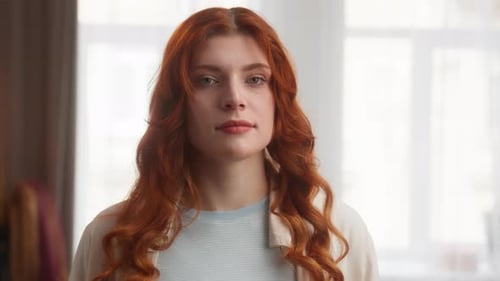 Smiling Woman with Red Hair Posing Indoors