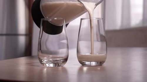 Smoothie Being Poured into a Glass at Home