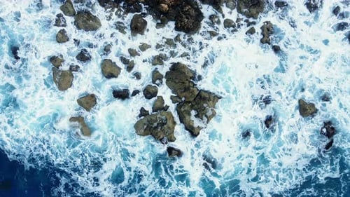 Flying Over Ocean Coastline Cliffside with Blue Pure Water Sea Waves Washes the Rocky Shore Above