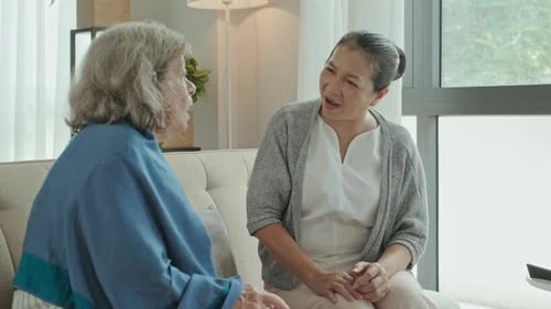 Senior Female Friends Speaking in Nursing Home