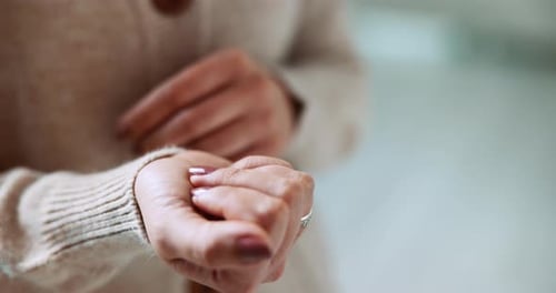 Woman Holding Small White Pills in Hand
