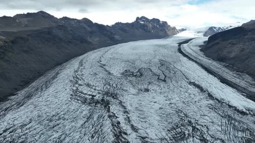 Aerial view of glacier between mountains, Iceland.