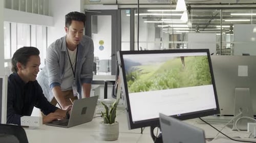 Businessmen Talking, Planning at Laptop in Office Businessman