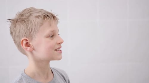 Child Brushing Teeth in Bright Bathroom