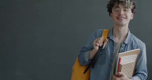 Smiling Young Adult Student with Backpack and Notebooks