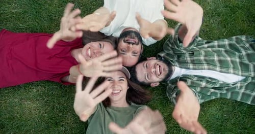 Top View of Happy Group of Girl and Guy Friends Waving Their Palms Up While Having a Happy Time