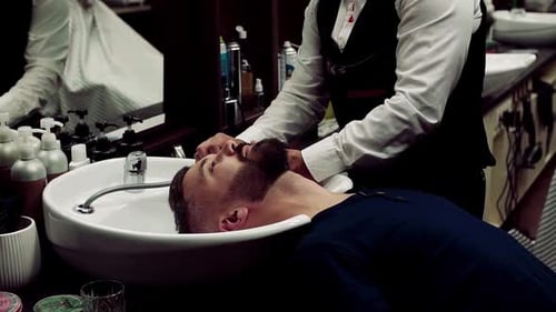 Hipster man visiting hairdresser for trendy style and professional grooming in barber shop