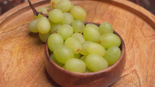 Fresh Green Grapes in Bowl on Wooden Platter