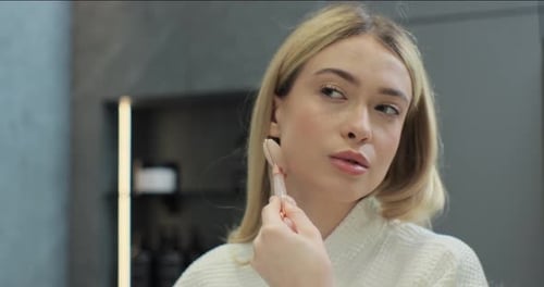 Close Up Woman with Healthy Skin is Getting Massage Face Using Jade Facial Roller Beauty Treatment