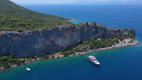 Beautiful view of the beach with boats, pure nature, sea and ships. Shot from a drone.