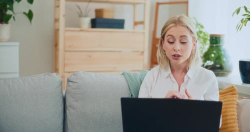 Young Woman Video Conferencing at Home on Laptop
