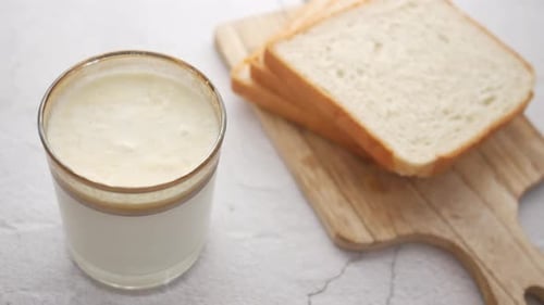 Glass of Whole Cream Milk on Table Cream of Milk