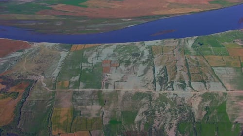 Blue river going from from the farms, Aerial view, Roads and trees spread in the crafted farms