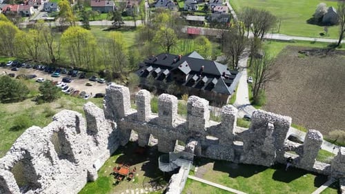 Medieval castle walls with a courtyard during a beautiful summer day surrounded by lush greenery, gr