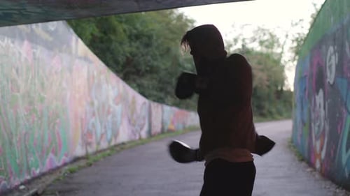 Wide Shot of Young Attractive Man Boxing In Underpass, In Slow Motion