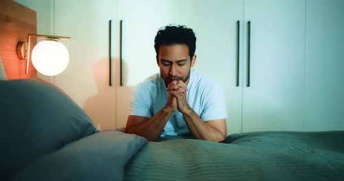 Man, praying and faith in bedroom, night and worship with routine, connection