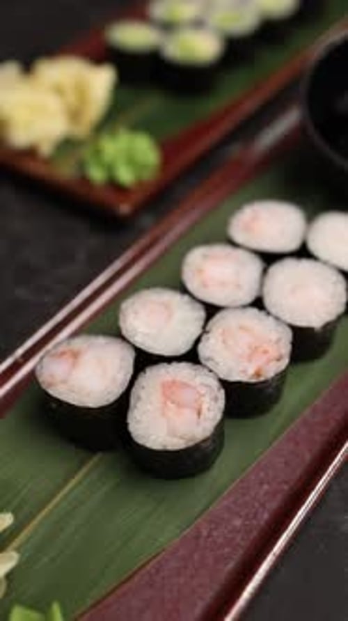 Close-up of delicious Japanese sushi rolls served fresh on a plate in a restaurant.