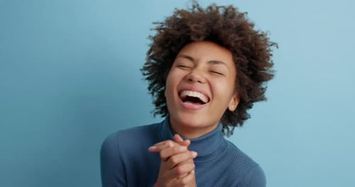 Woman Laughing With Joy in Studio Close-Up