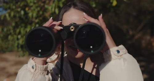 Woman Tourist Looking Through Binoculars