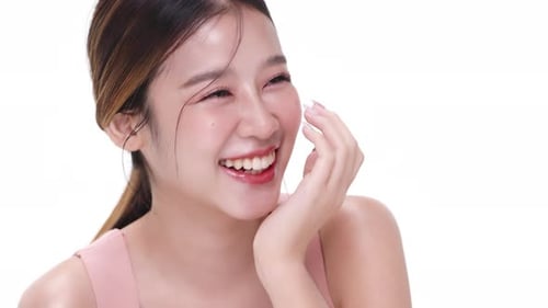 Close up portrait beautiful young Asian woman with healthy facial skin over white background.