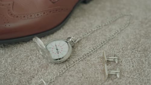 Groom's Accessories: Pocket Watch, Cufflinks, and Brown Leather Shoe