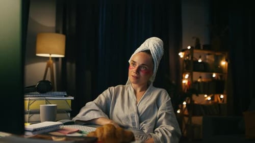 Woman in Robe Working at Computer Late at Night