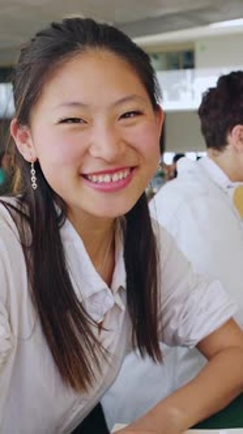 Young Student Girl Smile at Camera Sitting with Friends at Campus College