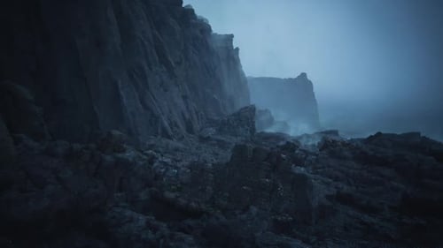 Harsh Moonlight Highlights Rugged Cliffs and Silent Pools Amid Drifting Sea Mist