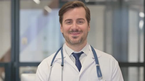 Portrait of Smiling Young Doctor in Clinic