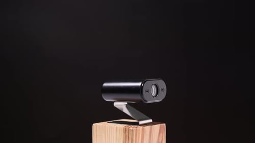 Webcam Technology on Wooden Block Against Dark Background