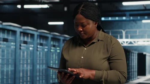 Admin Runs Equipment Checkups with Green Screen Laptop and Tablet in Data Center