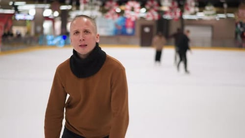 Fair-skinned Man Ice Skating at Indoor Rink