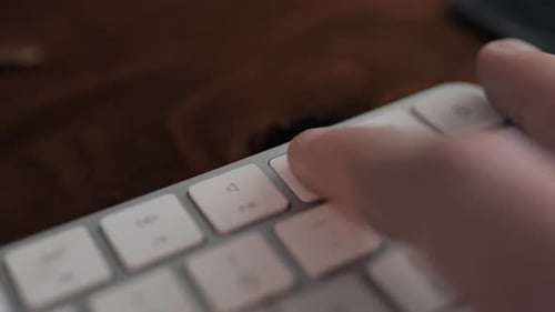 Close Up of Finger Pressing Keys on Keyboard