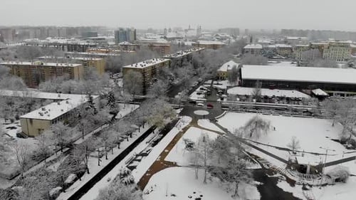 Aerial winter drone shot over a snowed in park