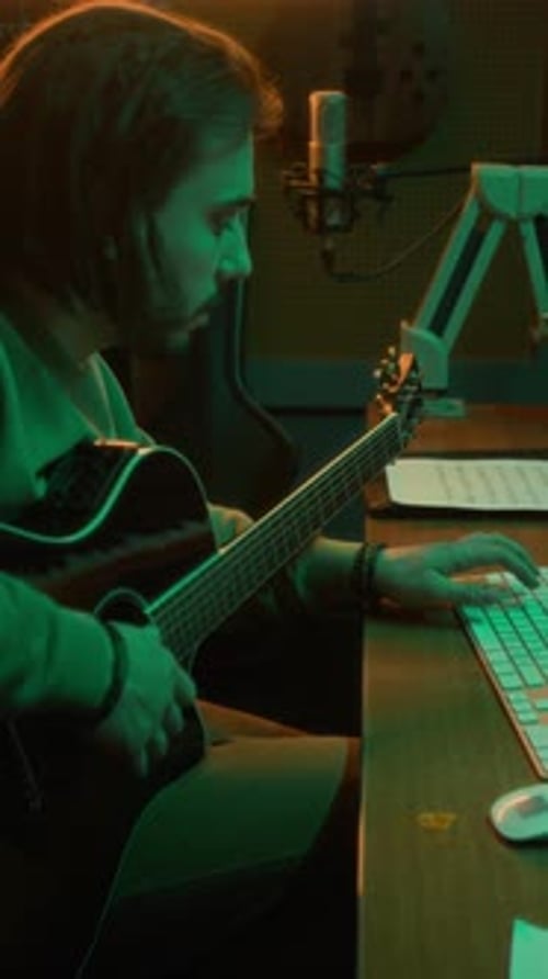 Vertical of Guitarist Recording Sound of Guitar in Studio