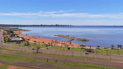 Aerial Establishing View of Main Street and Coastline Beach at Balneario Costa Sur in Posadas